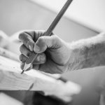 Passionate_Carpenter_at_Work._Woodwork_Concept._Carpenters_Hand_with_Pencil_Marking_the_Cut.
