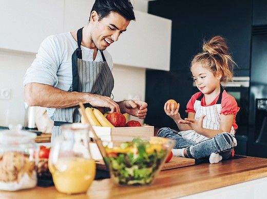 Young_man,_small_girl_and_healthy_food_in_a_domestic_kitchen.